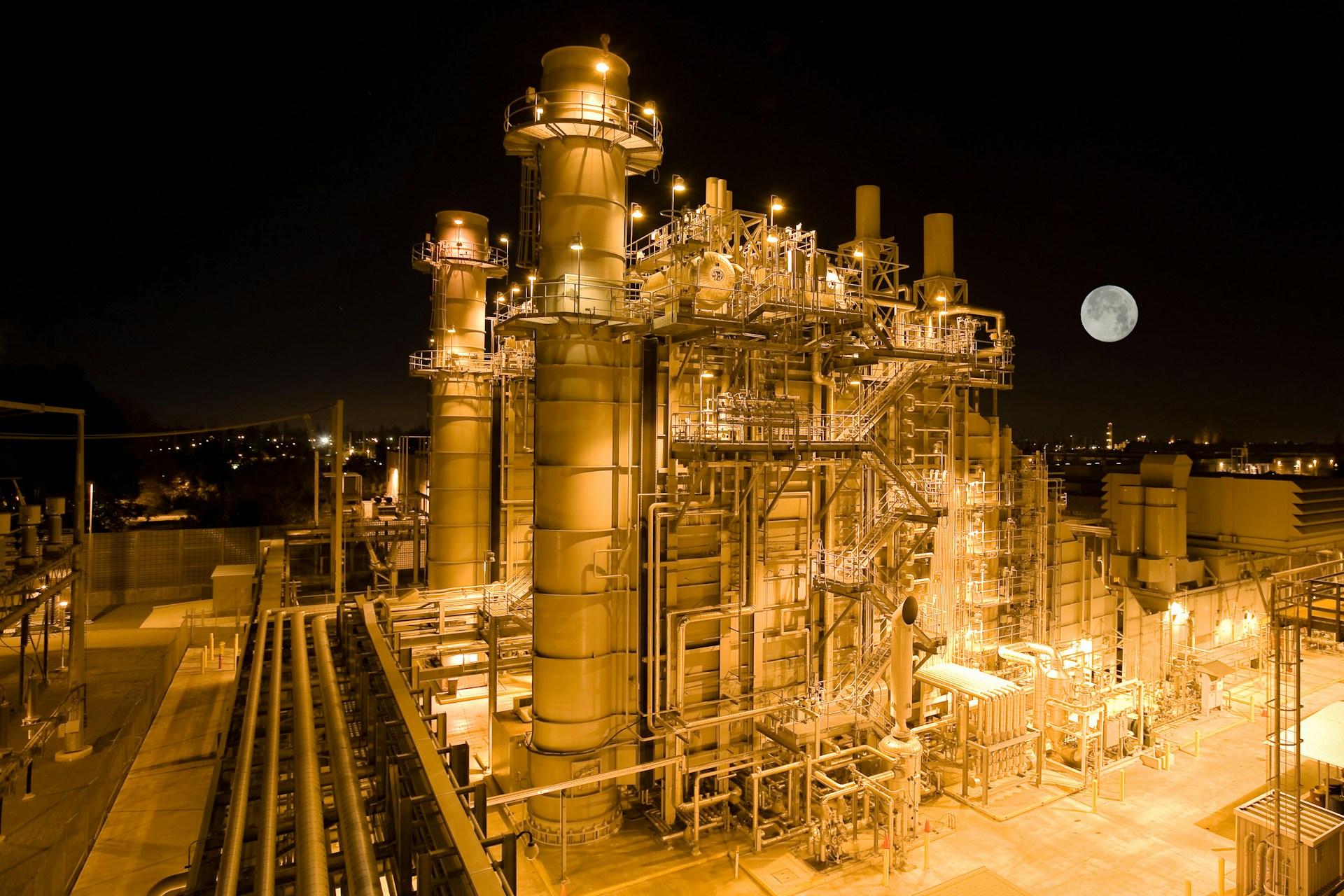 An illuminated civilian power plant at night.