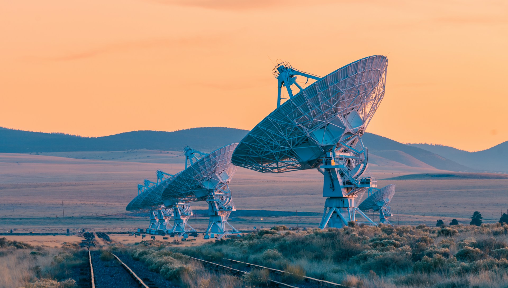 Radio telescopes at the Very Large Array in New Mexico at sunset.