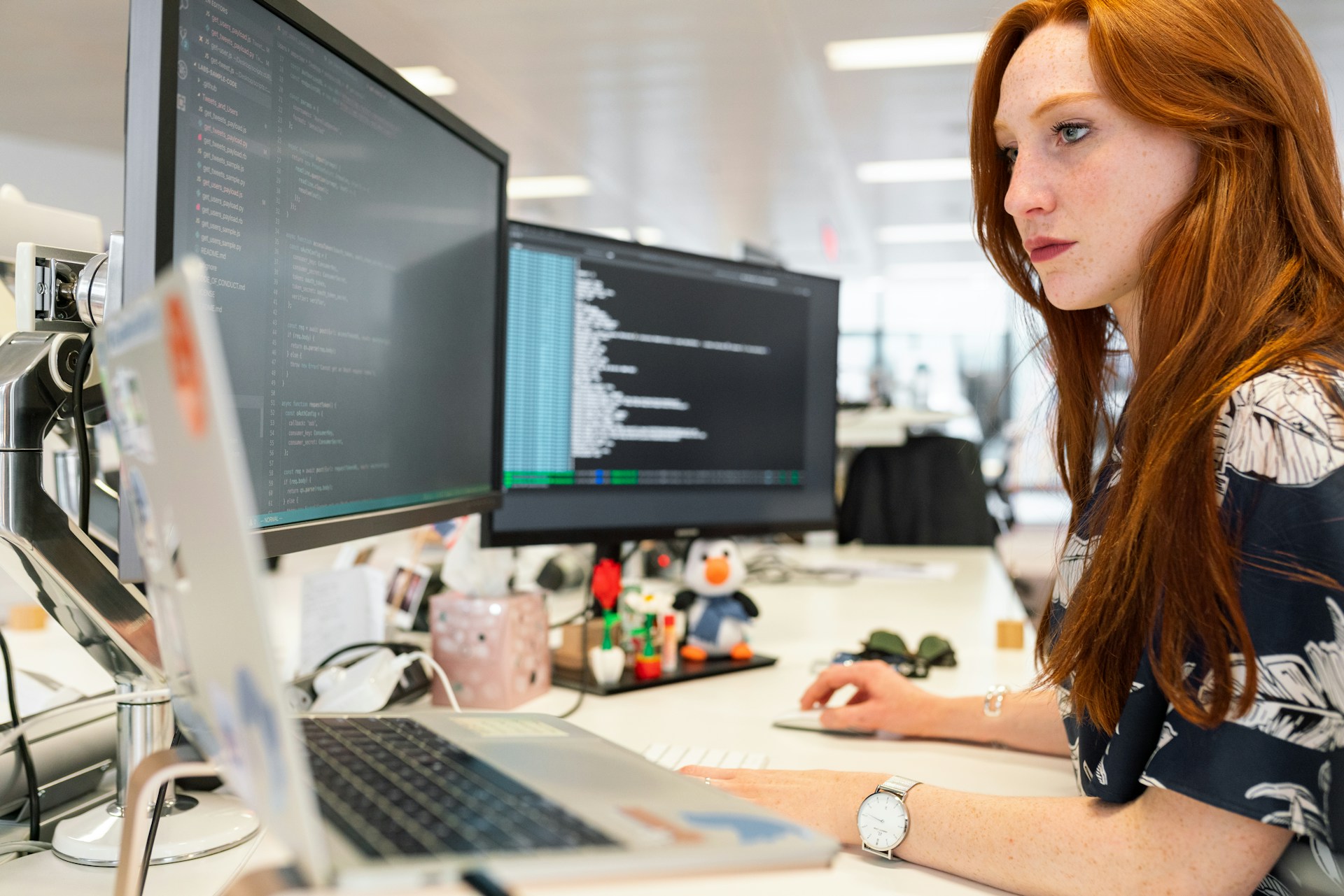 A software engineer works at a desktop computer.